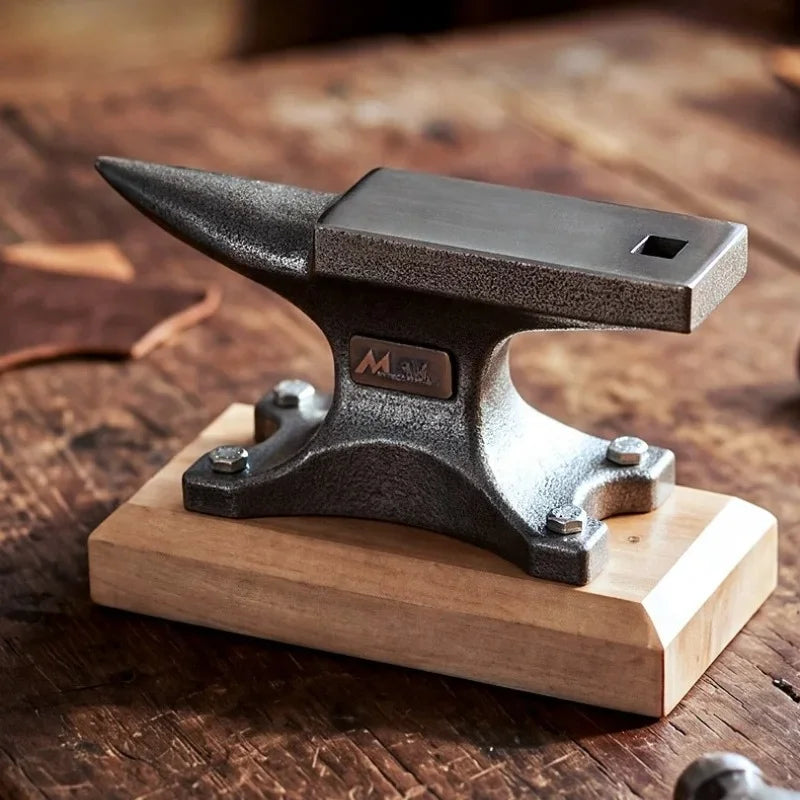 Horned bench anvil bolted to a wooden base, on a workbench